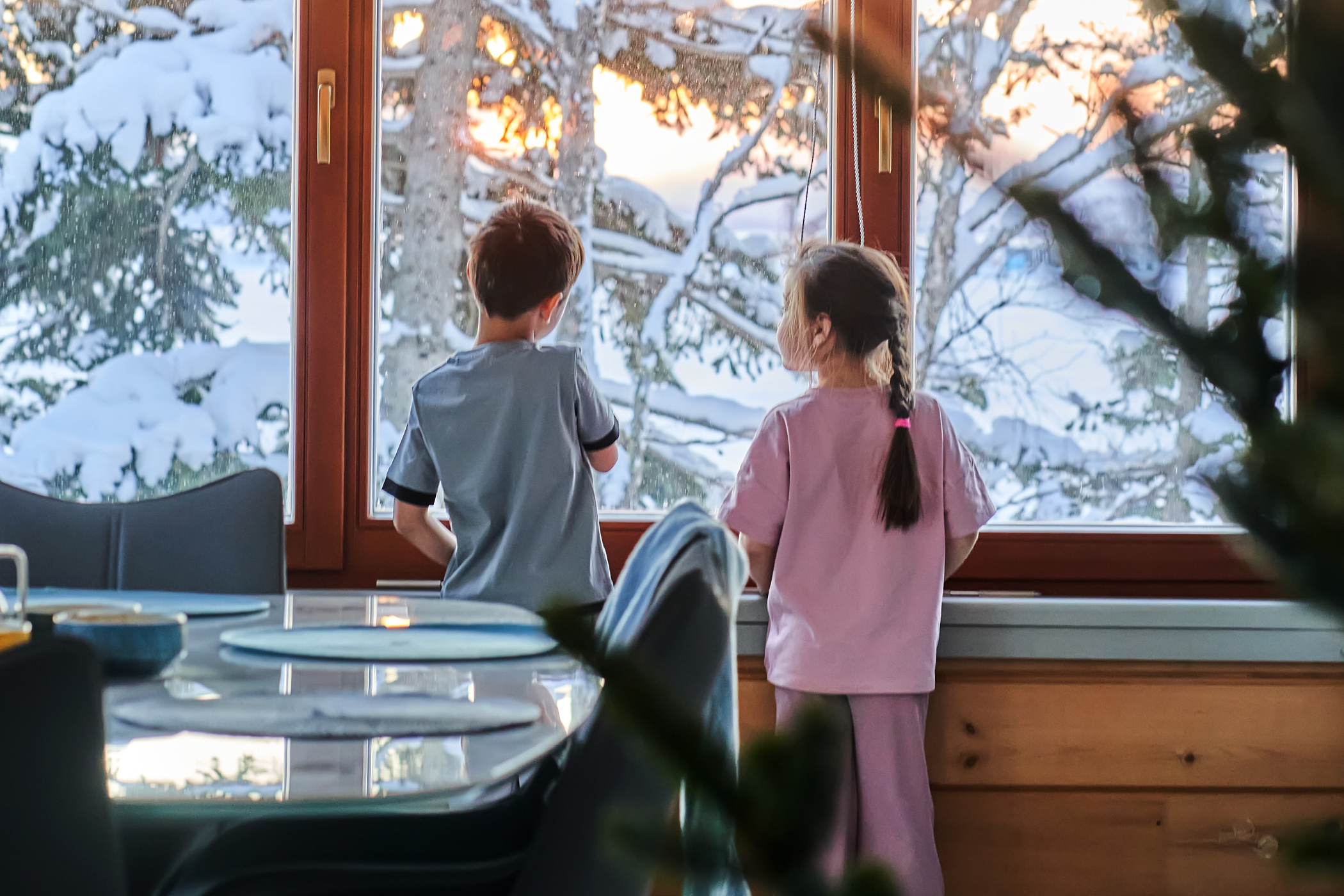 Children looking outside at the snow